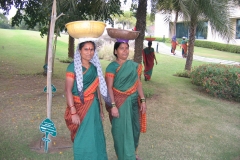 Indian women carrying baskets on their heads in Pune, India Indian women carrying baskets on their heads in Pune, India