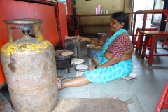 Lady Cooking on the Floor in Mumbai, India Lady Cooking on the Floor in Mumbai, India